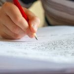 Graphology handwriting analysis person writing on white paper