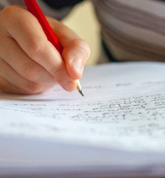 Graphology handwriting analysis person writing on white paper