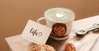 franchisees for life. white ceramic mug beside brown cookies on brown wooden chopping board