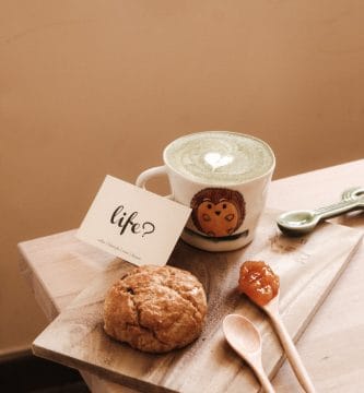 franchisees for life. white ceramic mug beside brown cookies on brown wooden chopping board