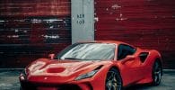 porque tu lo vales red Ferrari 458 italia parked beside red wall