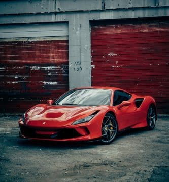 porque tu lo vales red Ferrari 458 italia parked beside red wall