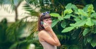 Tourism and Internet woman in white tank top and blue sunglasses