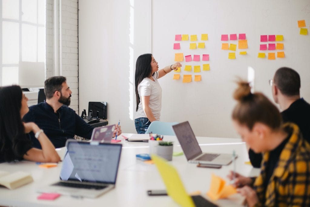 How to develop the Marketing Plan and Integrate it into the Business Plan 1 marketing plan, woman placing sticky notes on wall