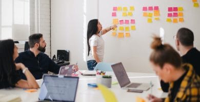 How to develop the Marketing Plan and Integrate it into the Business Plan 8 marketing plan, woman placing sticky notes on wall