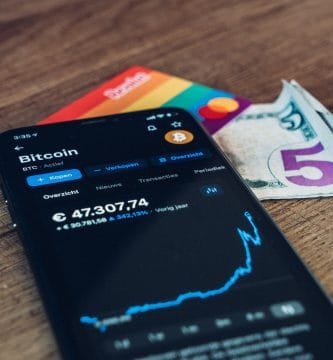 Tech stocks. black Samsung android smartphone on brown wooden table