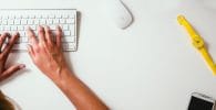 Marketing and Sales person typing on Apple Cordless Keyboard