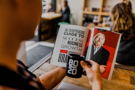 Profitable Franchises man reading magazine. Profitable franchising is one of the things any franchisee wants to achieve, but there are several things you need to keep in mind.