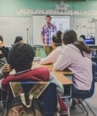 Teachers, man and woman sitting on chairs